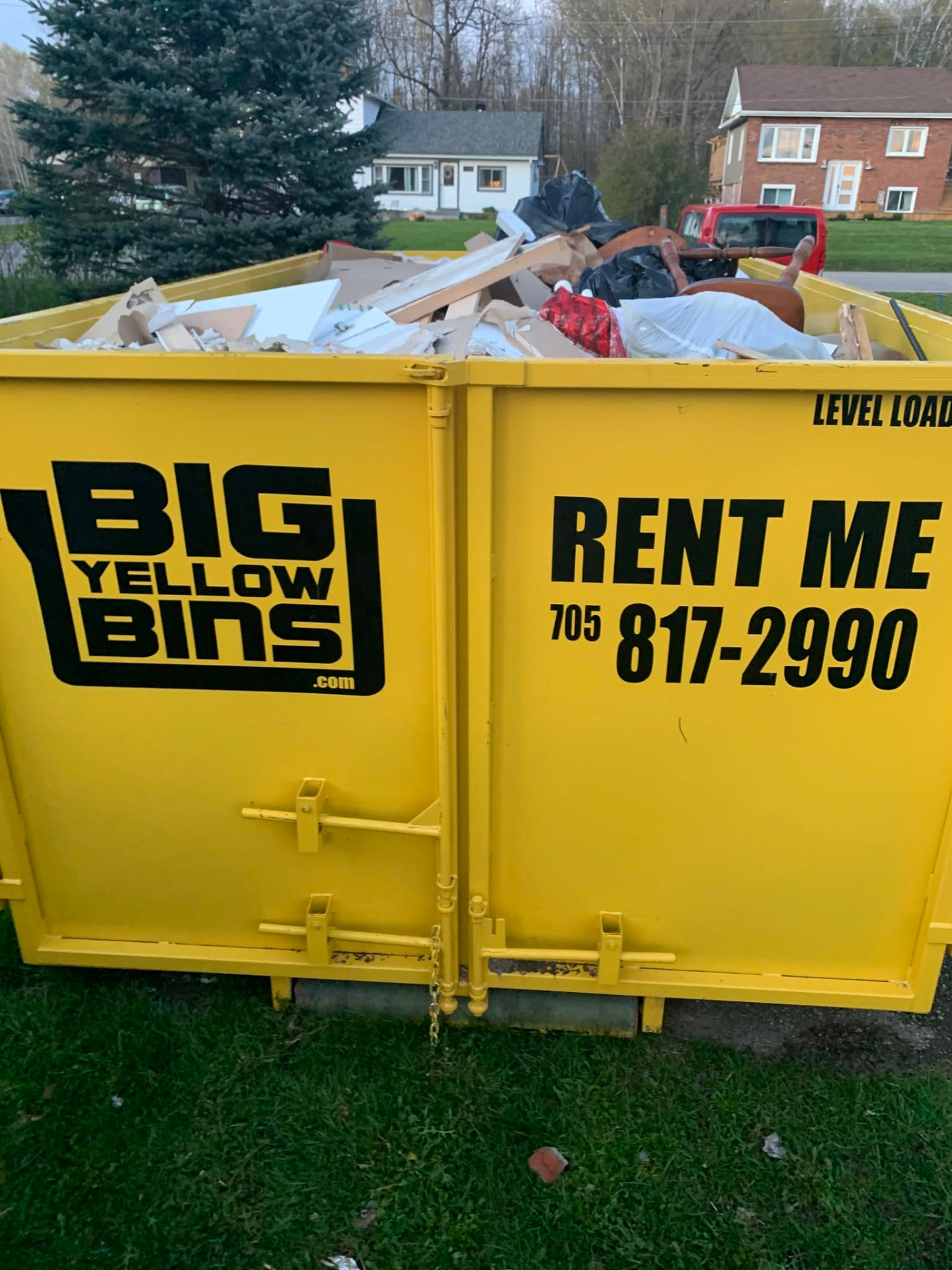 Loaded Big Yellow Bins dumpster during a home cleanup in Midhurst, Ontario