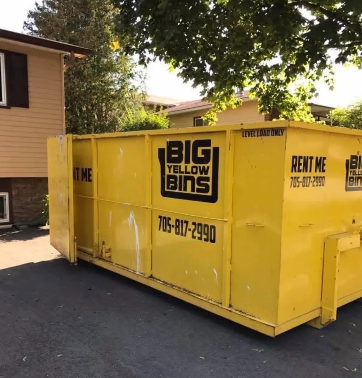 Big Yellow Bins 20 yard yellow roll-off dumpster placed on a residential driveway in Barrie, Ontario